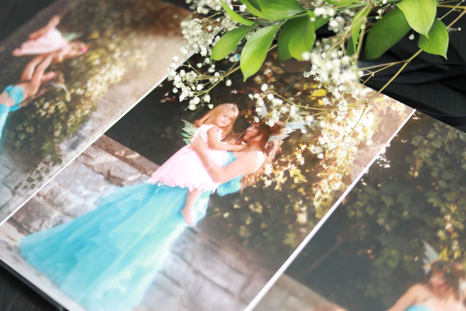 Photo album showing a portrait under flowering tree branches.