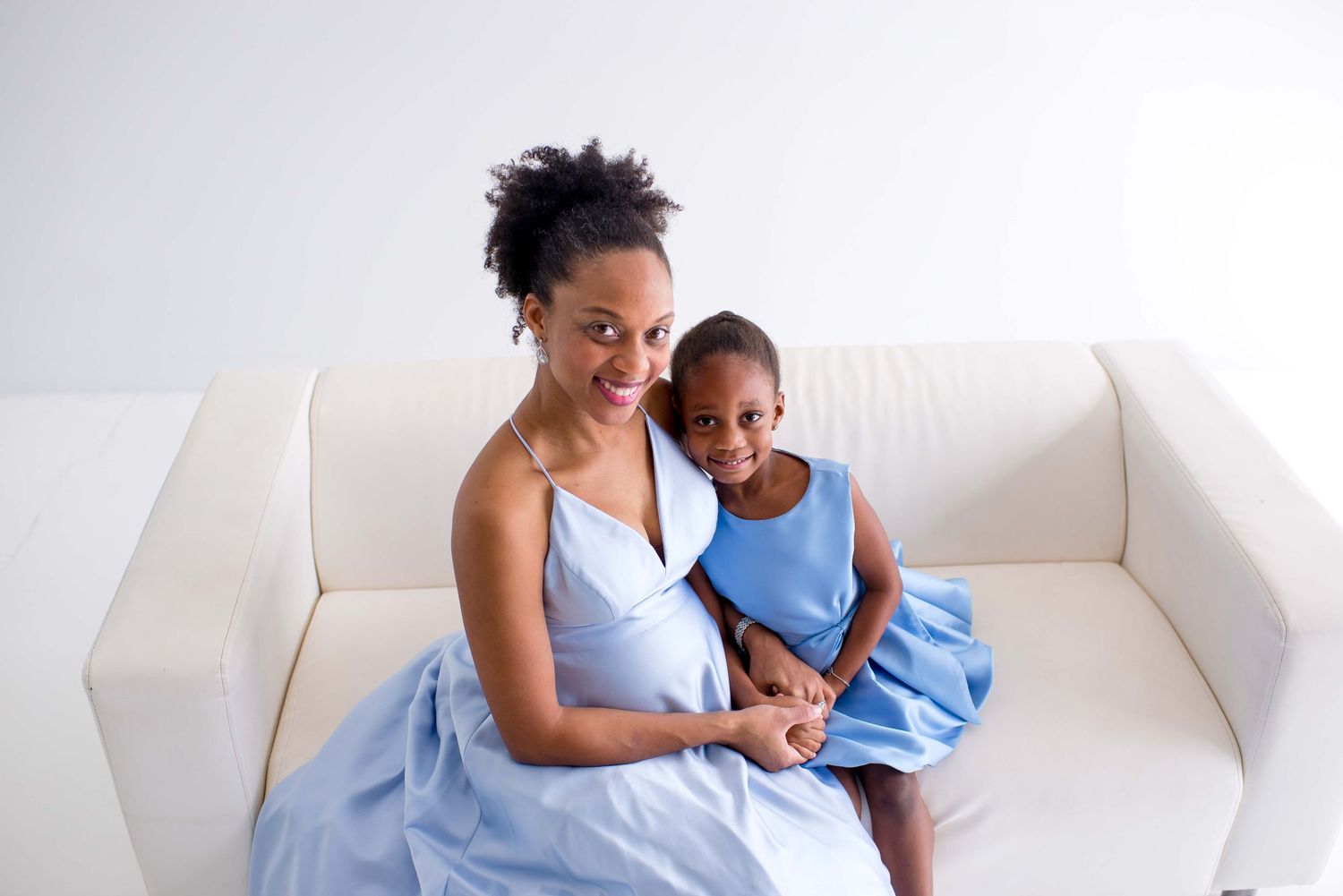 daughter and mother taking pictures together in a white studio houston texas