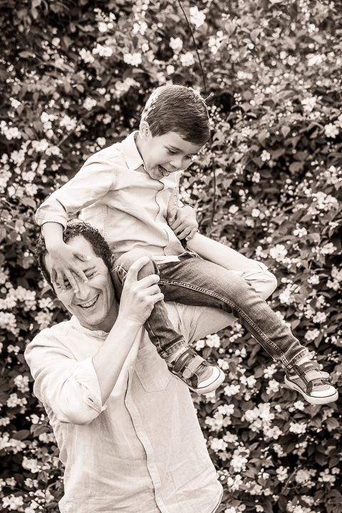 Black and white candid photos of playful moments between family members.