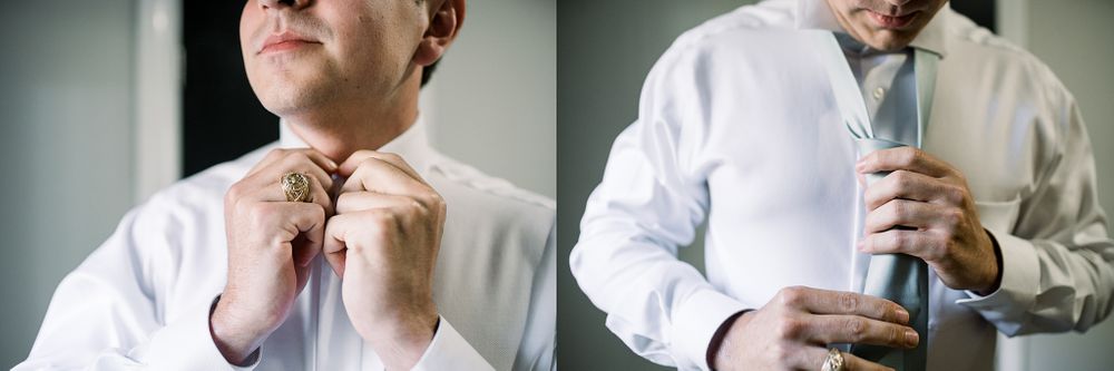 Close up details of groom adjusting tie and buttoning white dress shirt while getting ready.