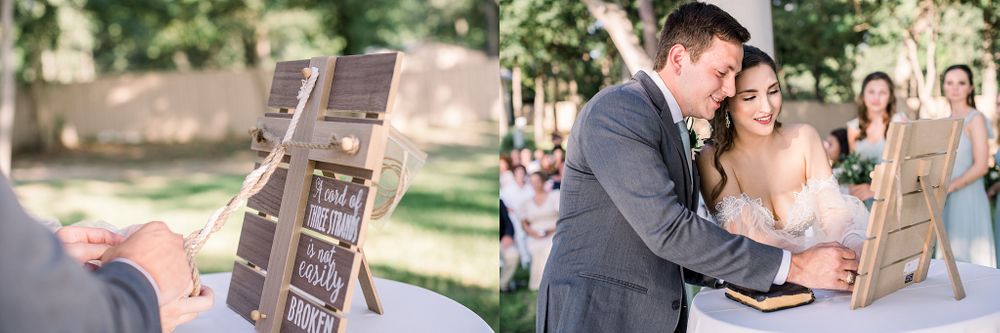 Wedding couple sharing emotional moment while looking through photo album during ceremony.