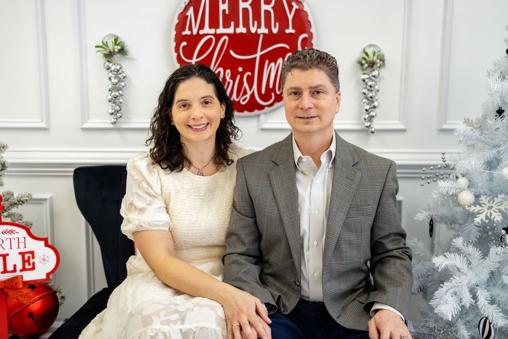couple in elegant wear posing for their christmas photo