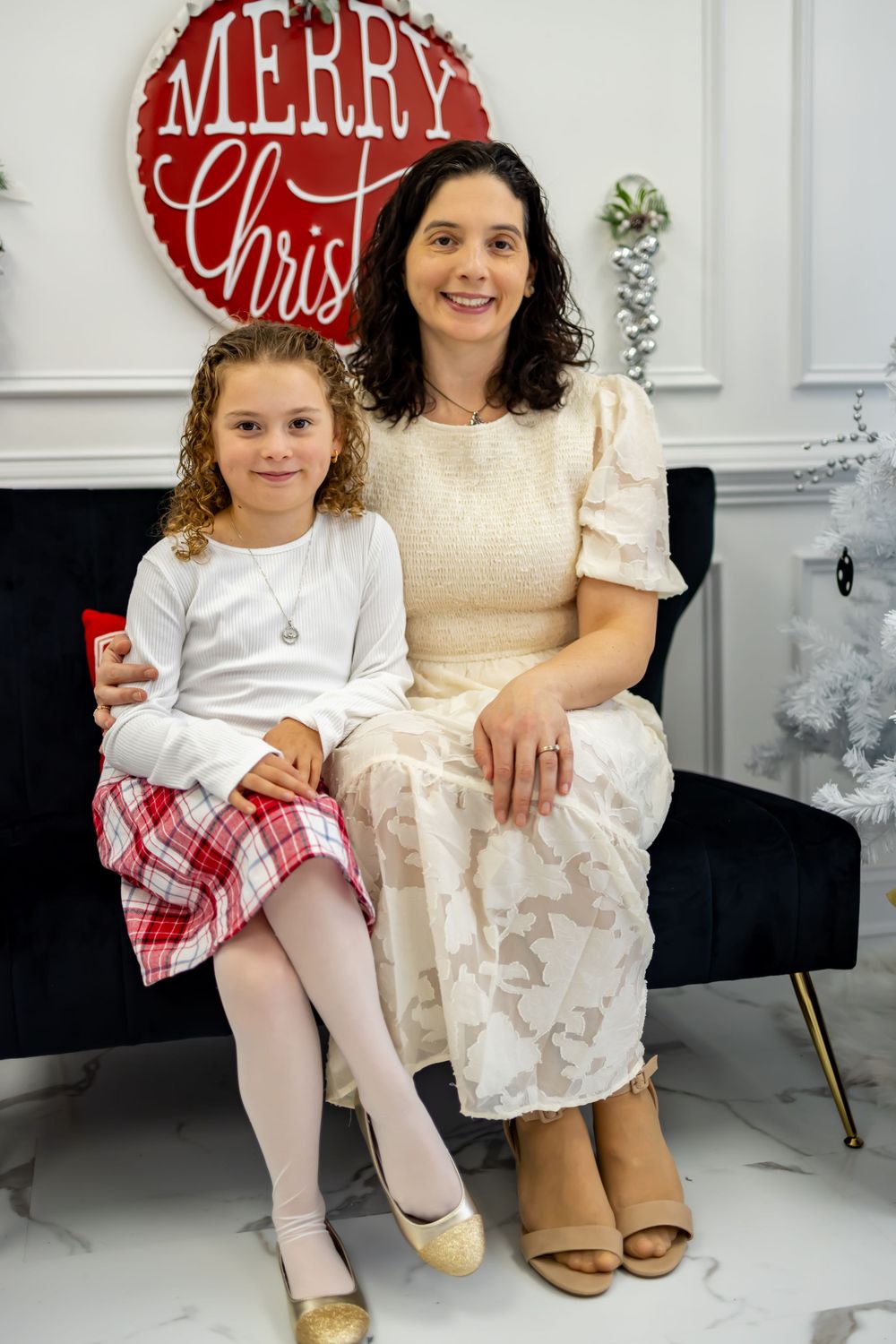 mother and daughter posing for their holiday photo