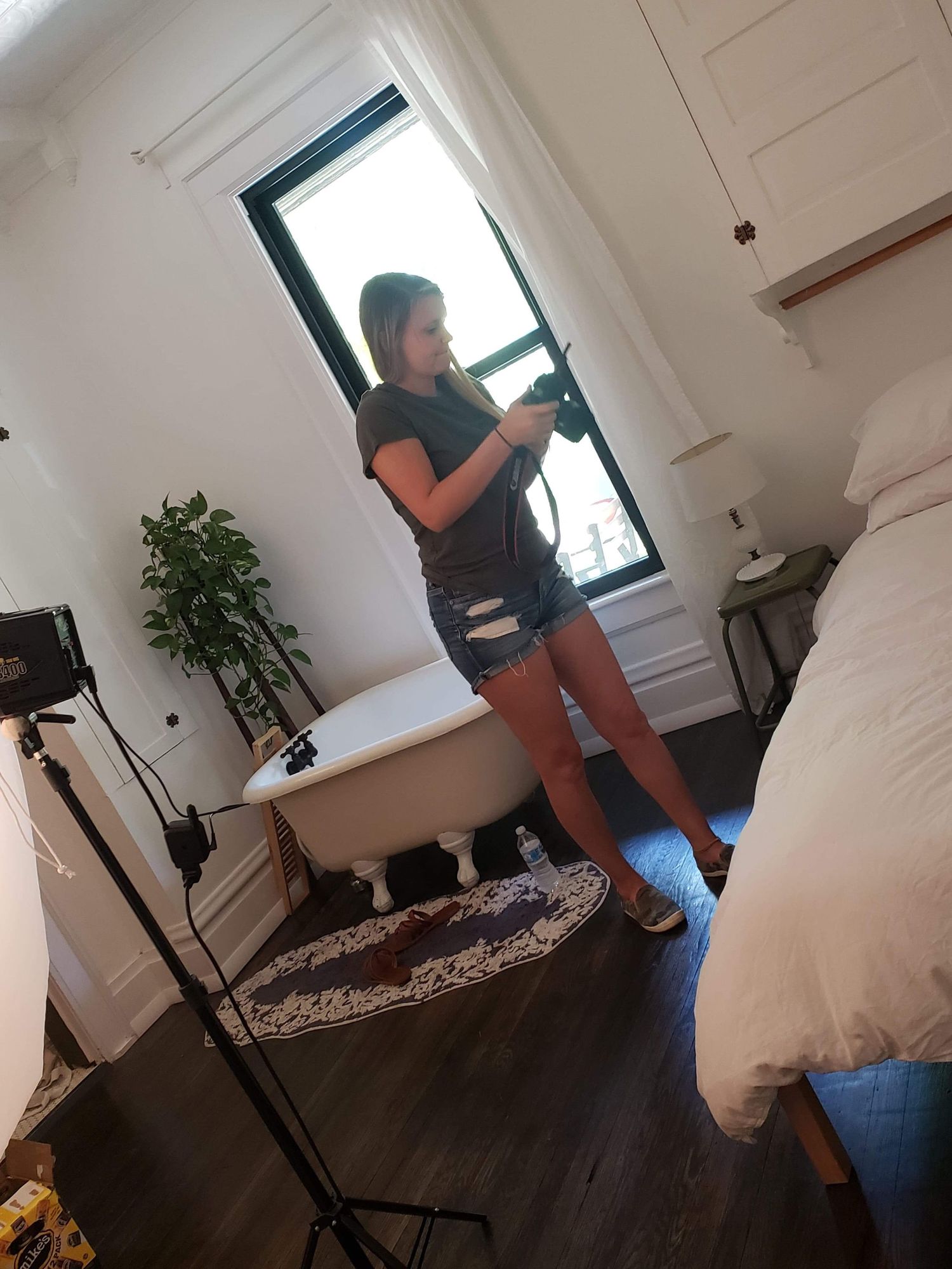 Behind-the-scenes photo shoot setup in a bright white room with photography equipment.