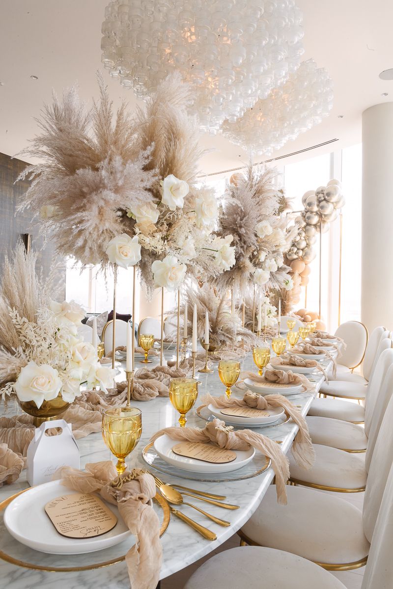 a side view of a baby shower table decor in nude tones with flowers at Hudson Yards by Paula Ortiz NY Family Photography