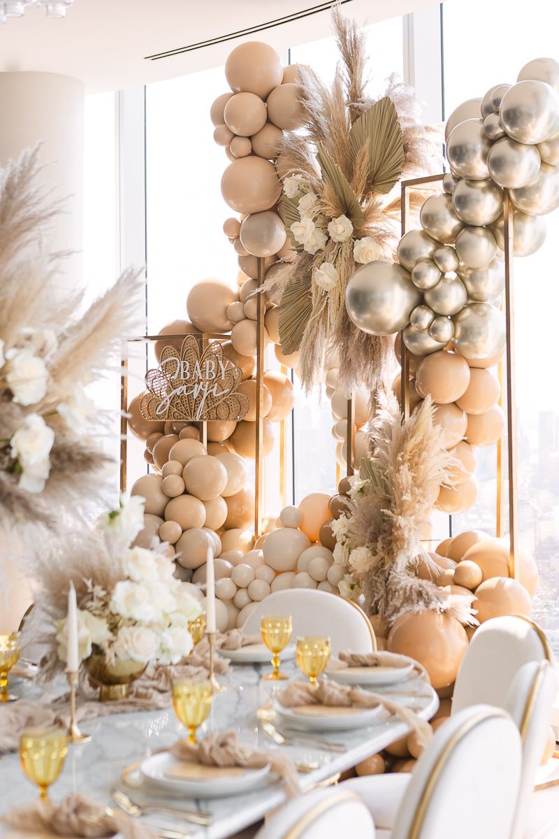 a balloon installation in nude, silver and brown for a baby shower at Hudson Yards photo by Paula Ortiz NY Family Photos
