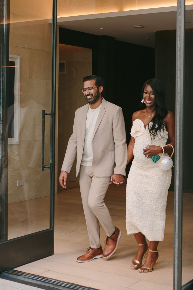 a candid scene of parents to be arriving at their baby shower in Hudson Yards photo by Paula Ortiz NY Family Photography