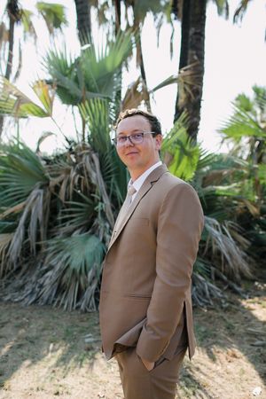 A groom shows off his wedding attire for his bushveld wedding in South Africa.