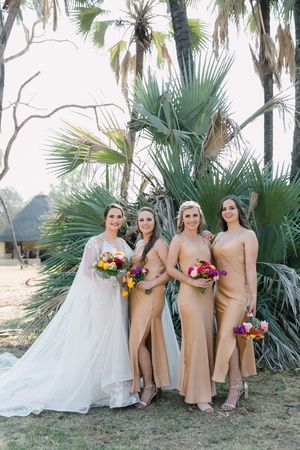 A bride and her bridesmaid in front of lala palms in Africa as captured by Dust and Dreams Photography.