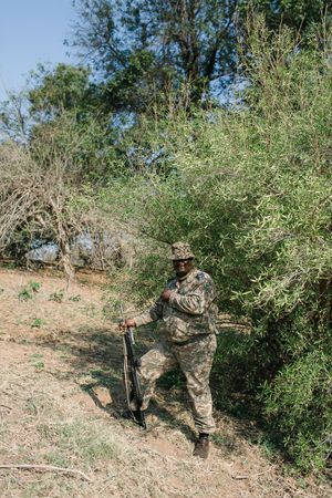 A field guide guards the guests at a safari wedding in the Kruger National Park.