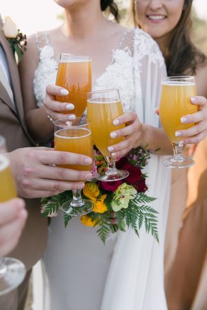 The wedding party toast with a craft beer made by the groom himself.
