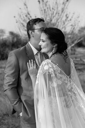 A monochrome moment showing off the bride in her custom made wedding dress and cape.