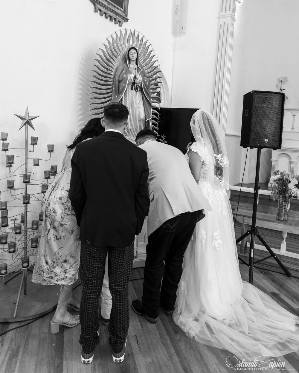 Black and white wedding ceremony photos showing traditional religious statues and decorations.