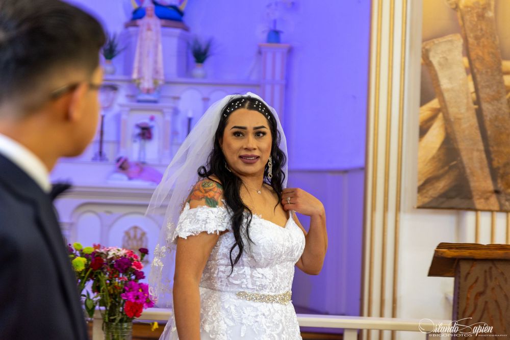 Wedding ceremony moments captured with purple lighting and elegant church decorations.