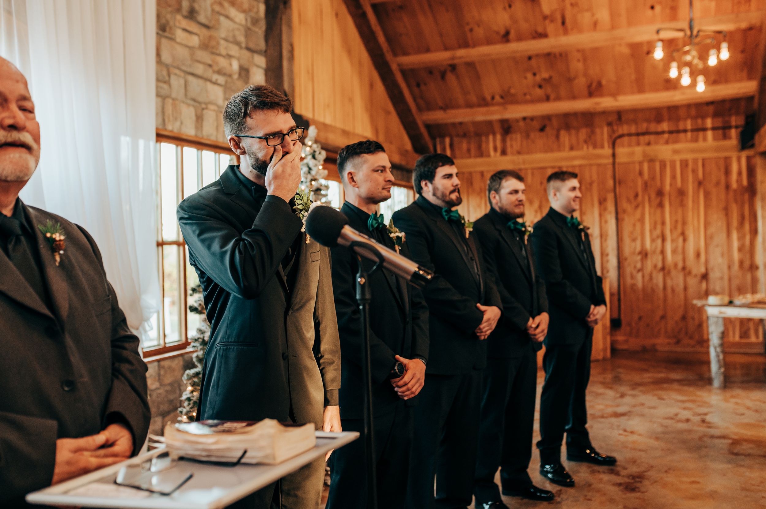Groom's emotional reaction to bride walking down the aisle.