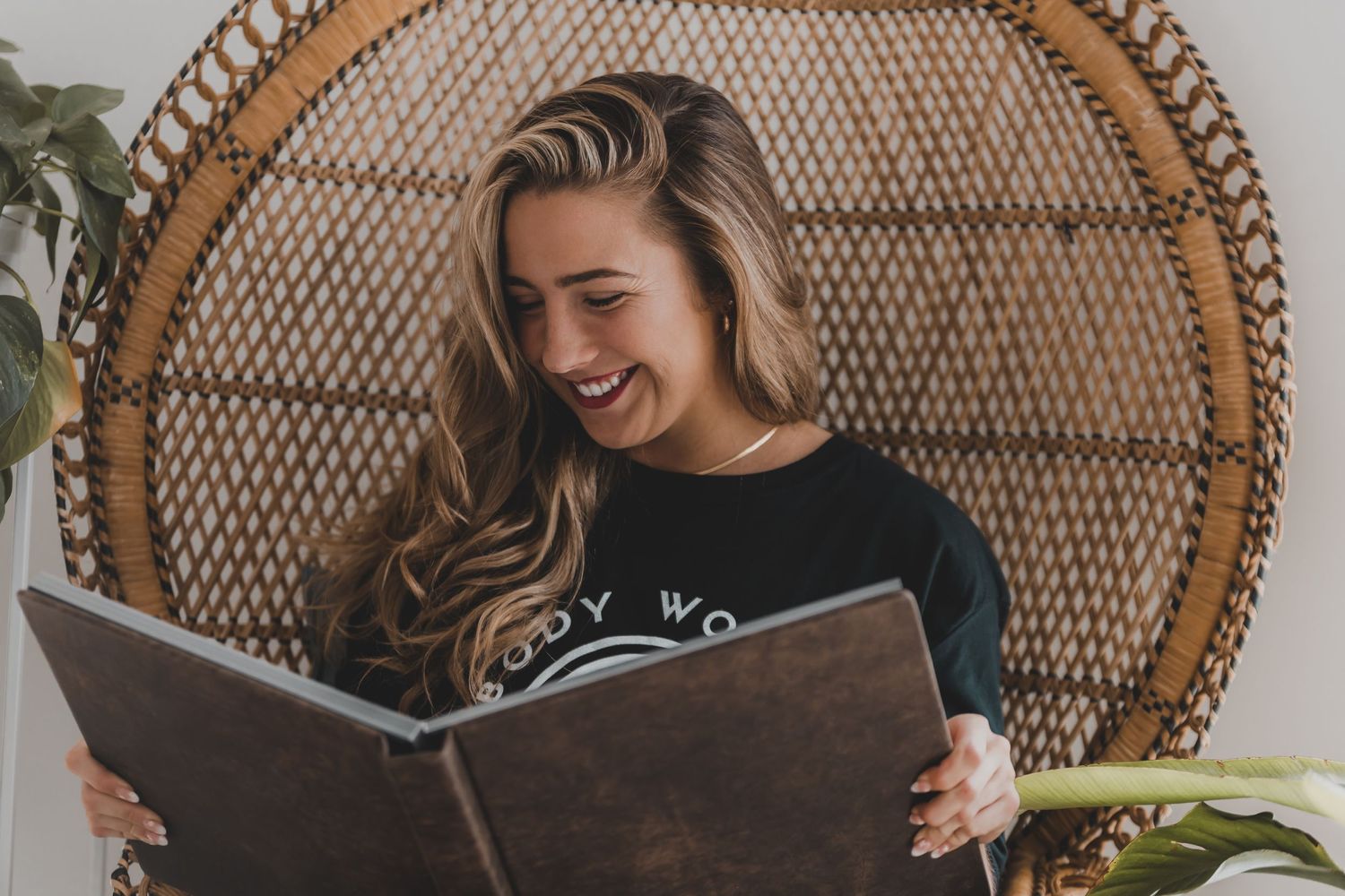 HaeBae looking through a luxury album and feeling beautiful. Barrie Boudoir Photographer