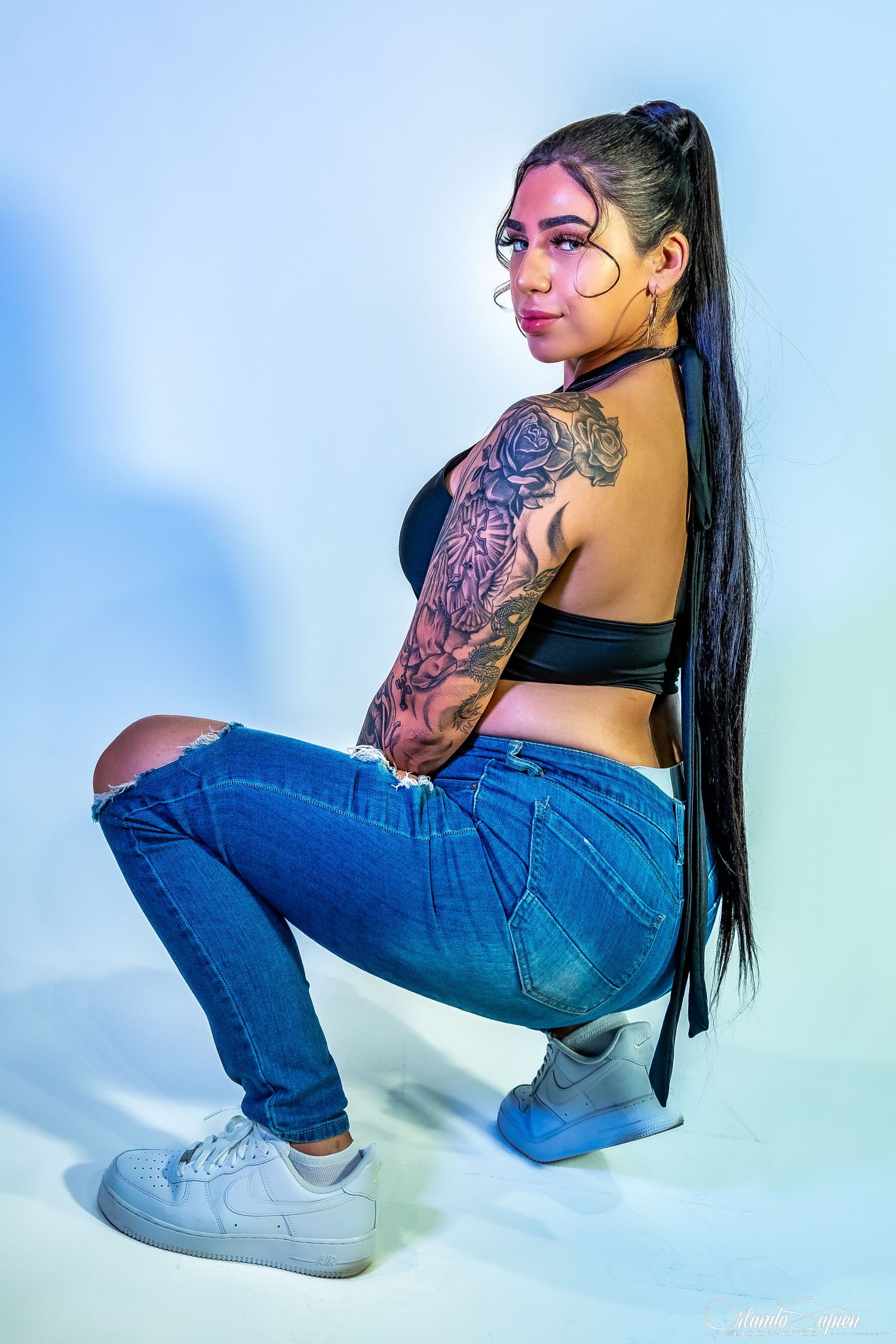 Artistic photo series showing denim fashion and tattoo art against blue background.