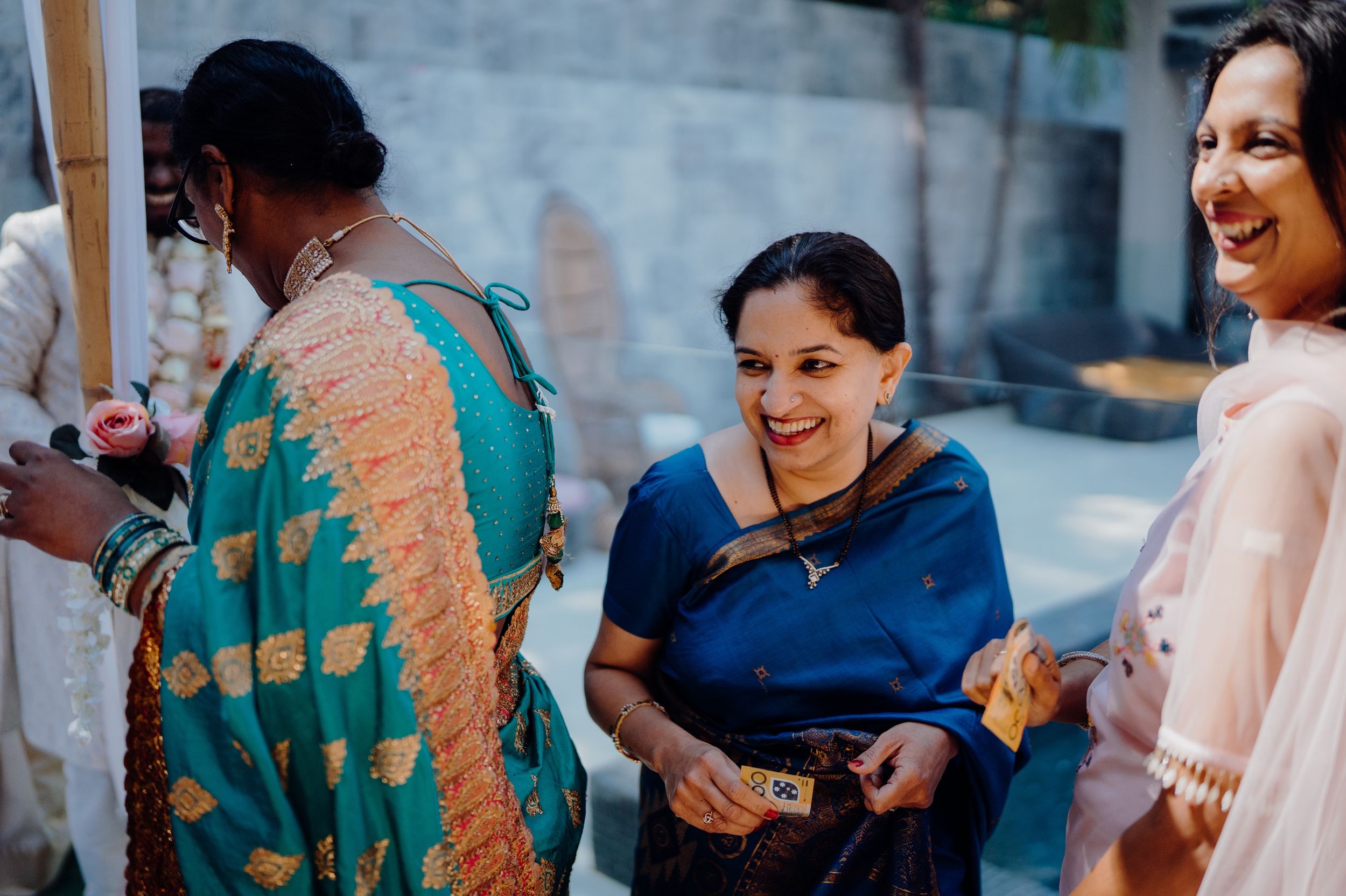 Wedding guests in traditional attire share a joyful moment during the celebration.
