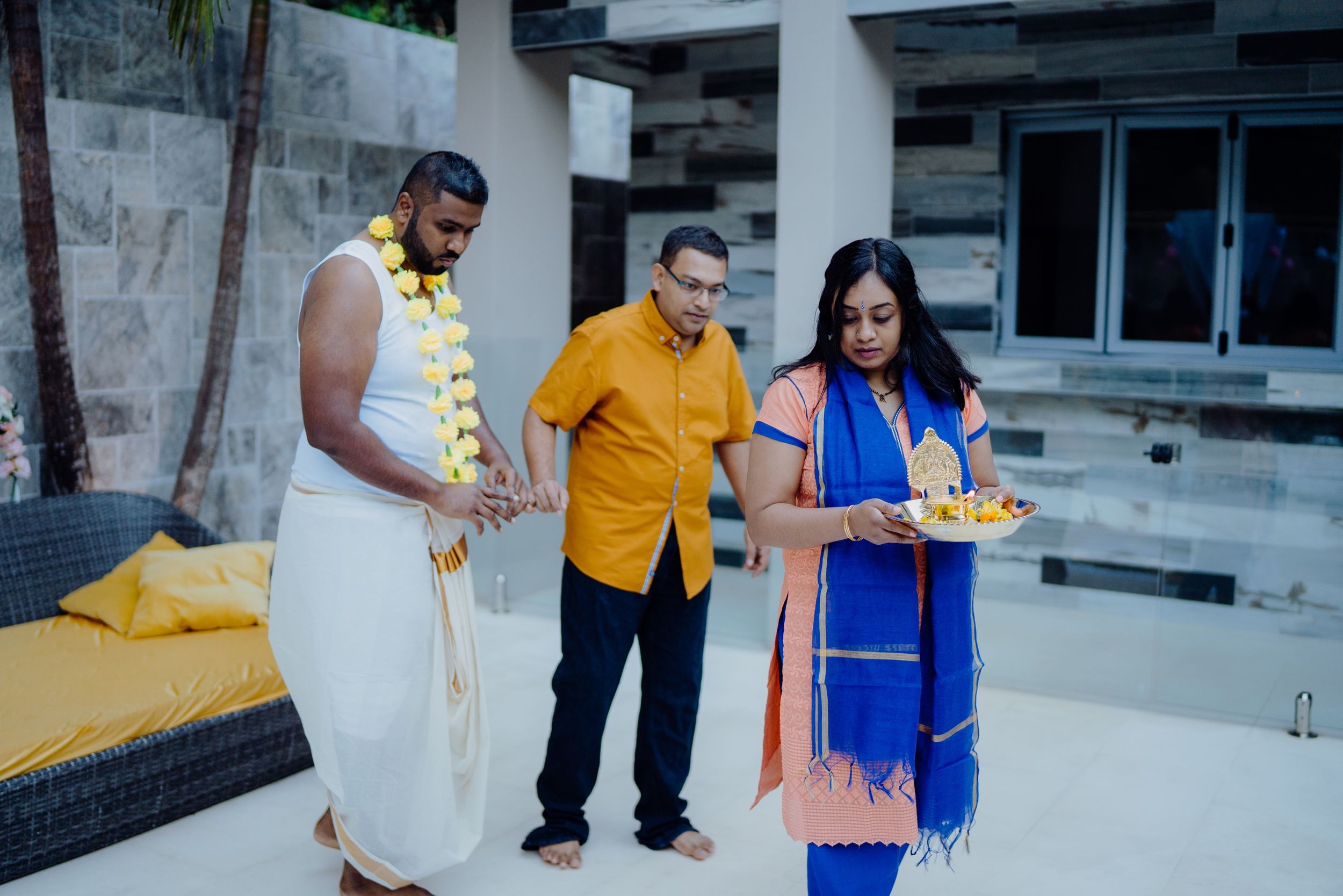 Traditional Indian ceremony participants dressed in colorful attire performing rituals.