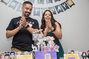 Party decorations and themed cake display with banner hanging in background.