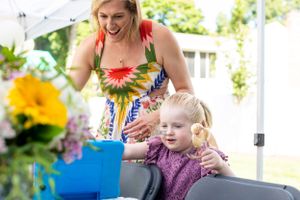 A celebratory moment at an outdoor party with bright sunflowers in the background.