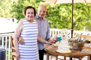 Couple celebrating at an outdoor party with a decorated table setting.