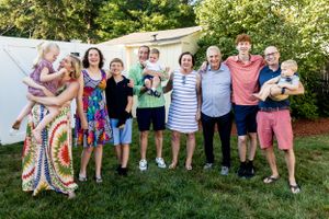 Group photo of people gathered outdoors on a sunny summer day.