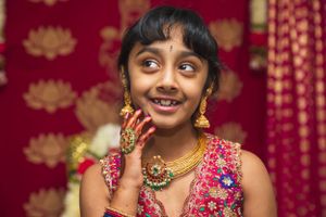Traditional Indian celebration with decorative jewelry and festive attire.