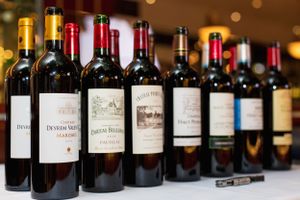 Row of premium Bordeaux wine bottles lined up on display.
