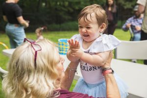 A joyful moment captured during a casual outdoor gathering with light-hearted interaction.