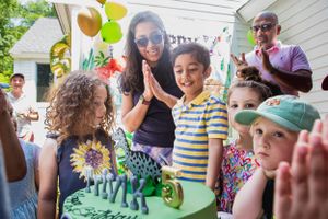 Outdoor birthday party celebration with balloons and decorations.