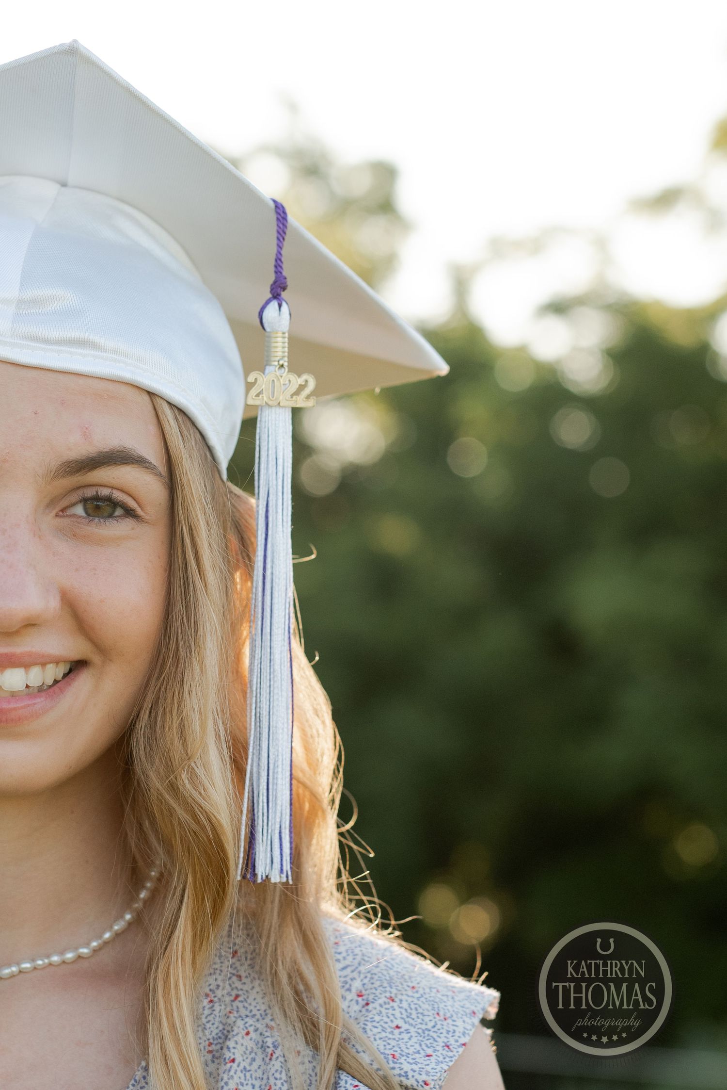 Close-up shot of a graduate's cap with tassel against a bokeh background.