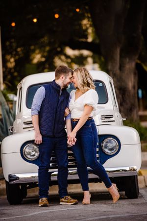 Romantic vintage scene with a classic white truck as backdrop in evening light.
