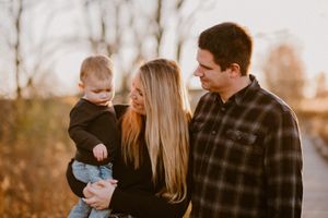 An intimate family portrait against a bright winter sky.