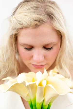 Close up portrait with soft white calla lilies in foreground.