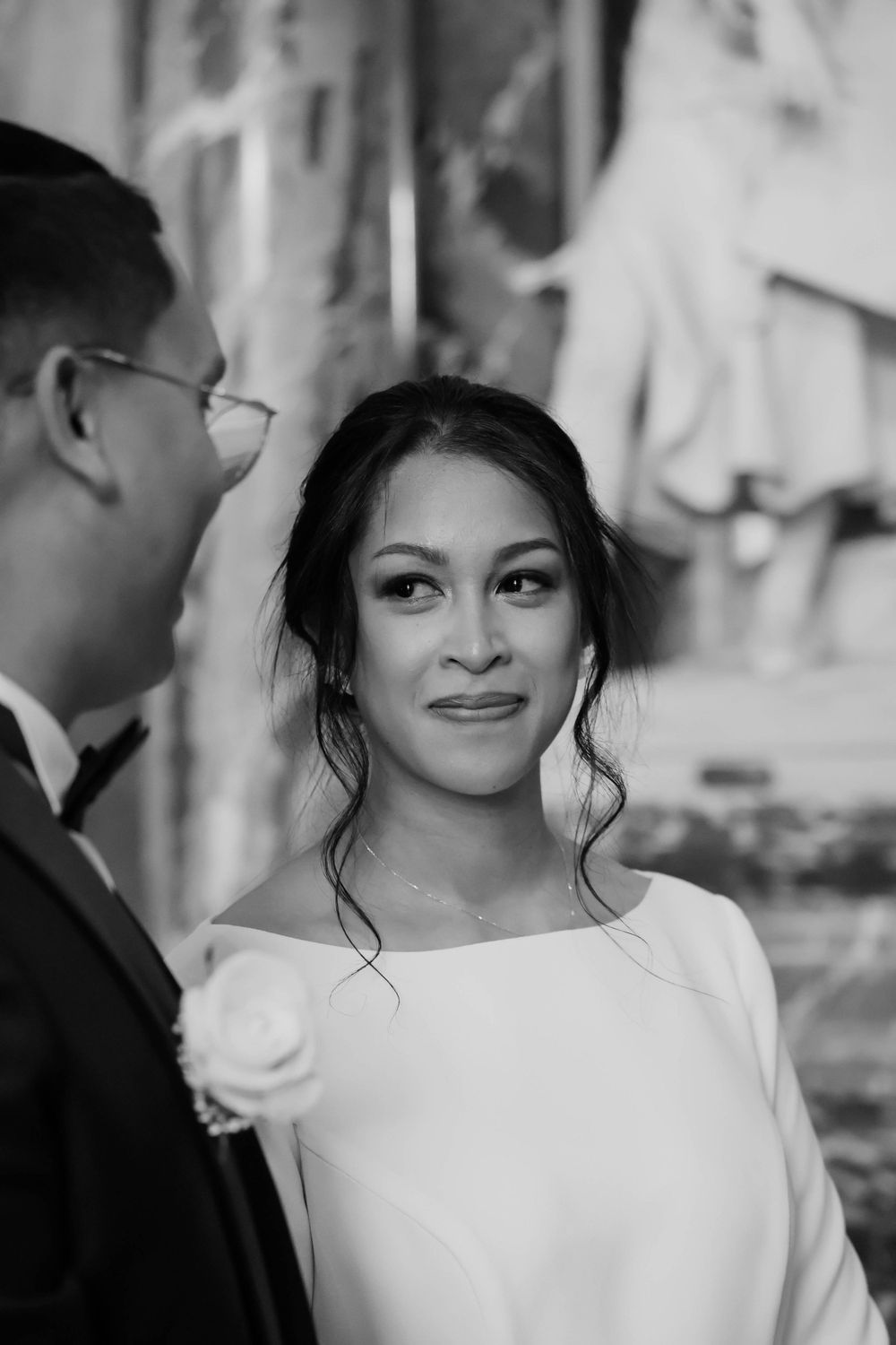 An intimate black and white portrait of newlyweds sharing a moment together.