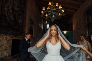 Gorgeous bride getting ready, wearing a long veil.