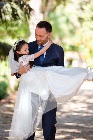A white dress flows gracefully during a playful outdoor moment.