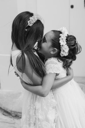 Black and white sequence of romantic wedding poses with flowing white dresses.