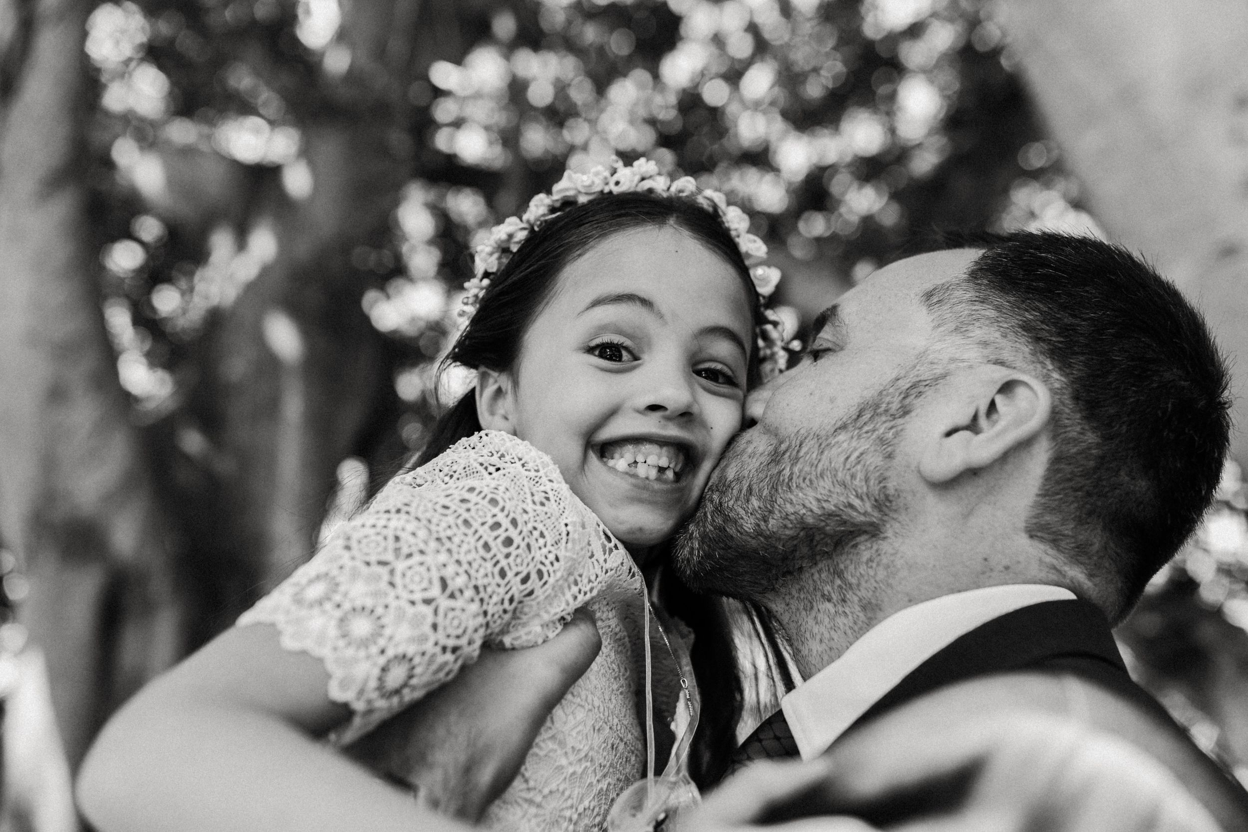 A romantic wedding photo sequence showing a couple kissing in an outdoor garden setting.
