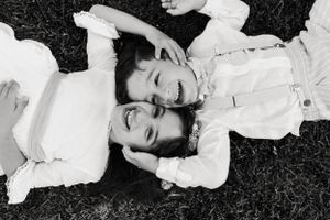 Black and white portraits showing joyful expressions against dark background.