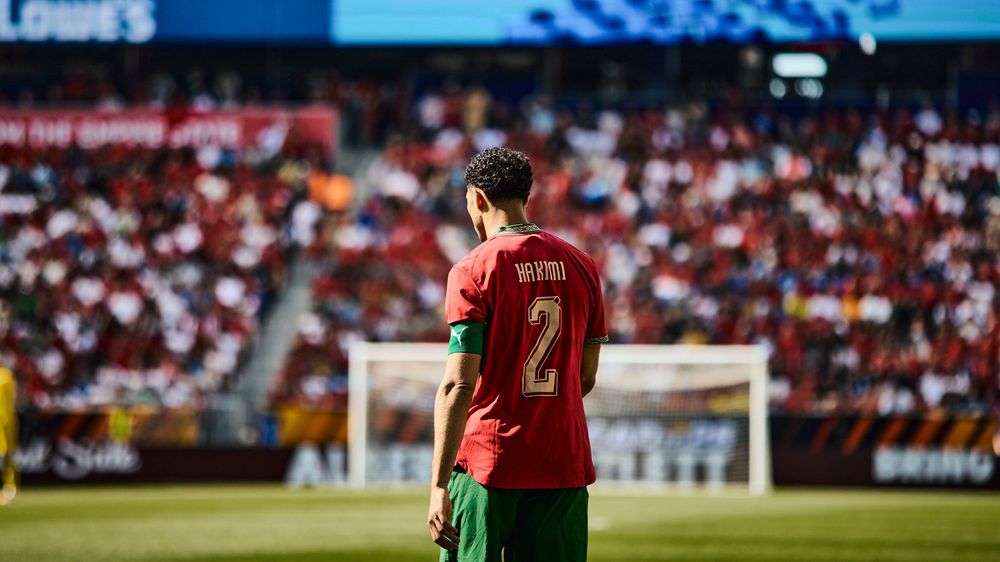 Portugal footballer wearing number 2 jersey stands on pitch during international match in packed stadium.