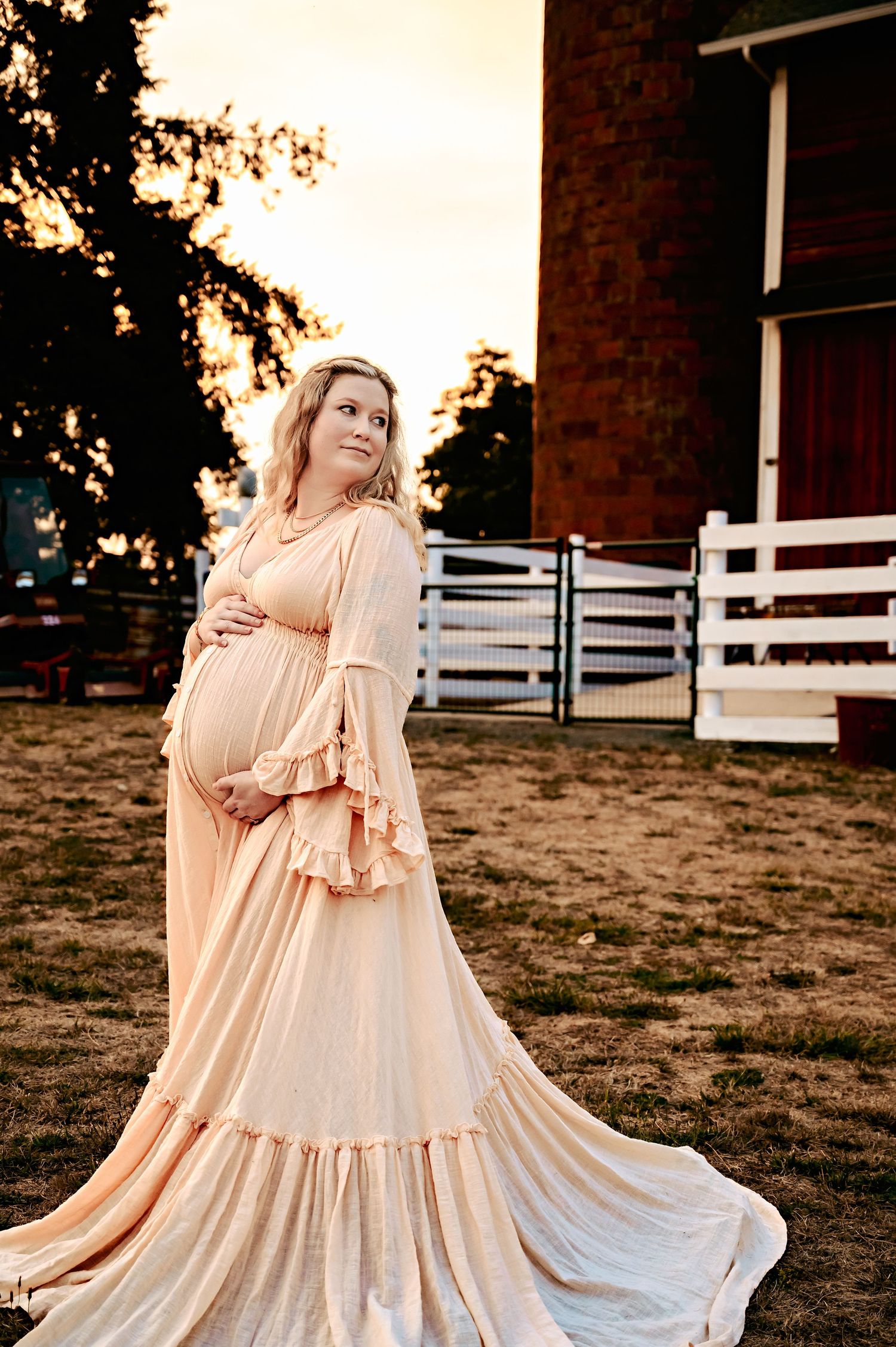 Flowing peach-colored tiered dress photographed in a series against a natural outdoor setting.