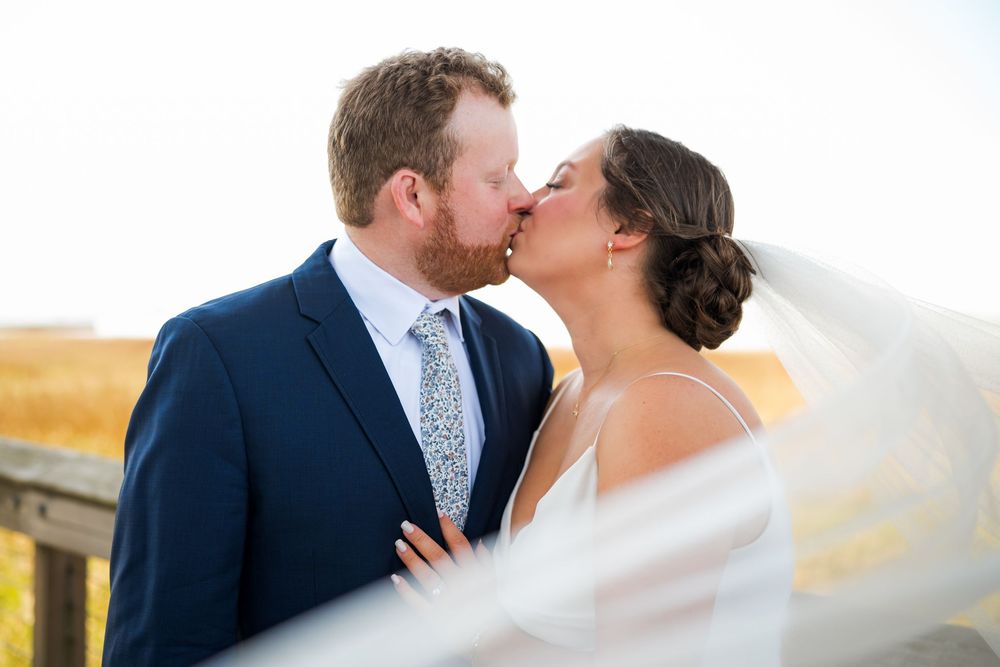 Newlyweds sharing a kiss with veil flowing in the wind, Charleston SC
Chelsea Marne Photography
South Carolina Photographer