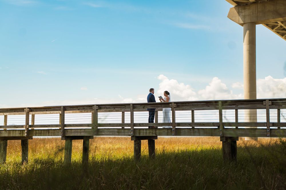 Couple standing on a pier at during first look  for Charleston Wedding

Chelsea Marne Photography 
South Carolina Photographer