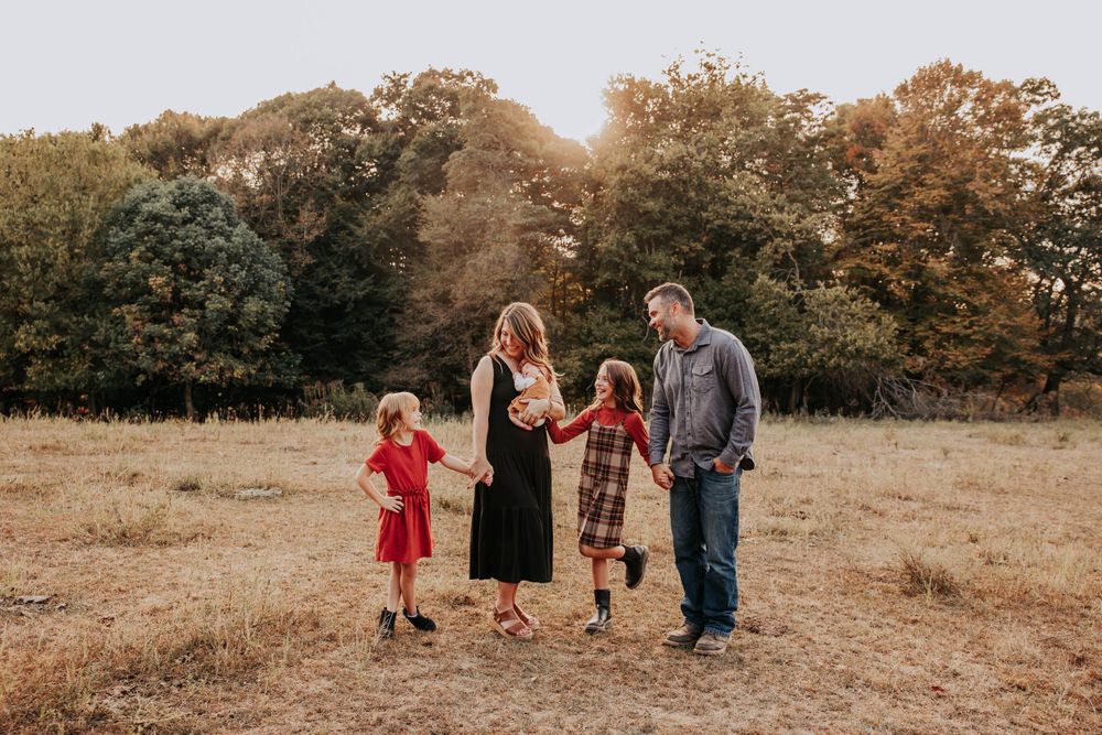 Family portrait sequence captured during golden hour in a rustic autumn field setting.