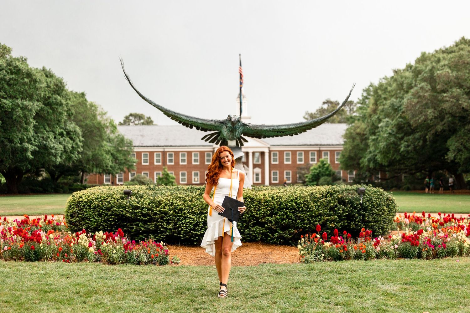 Graduation senior at the University of Wilmington North Carolina taking her senior portraits