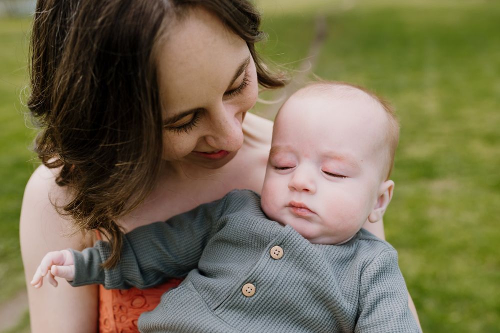 Mom snuggles baby