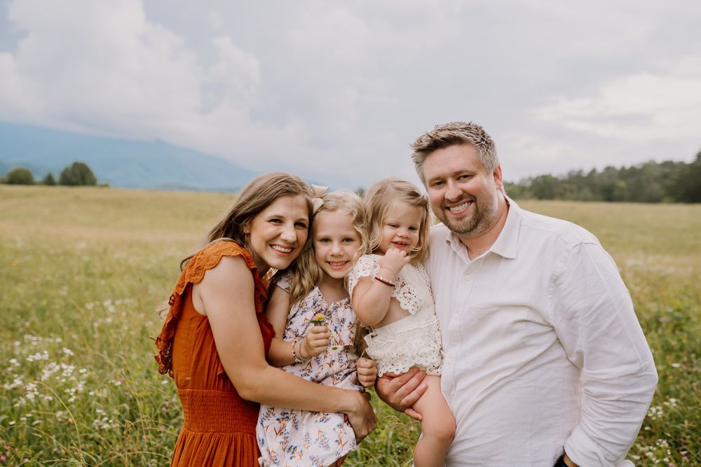 family smiles at camera during smoky mountains session