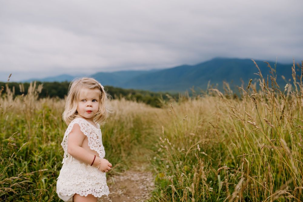 Little girl walking through field